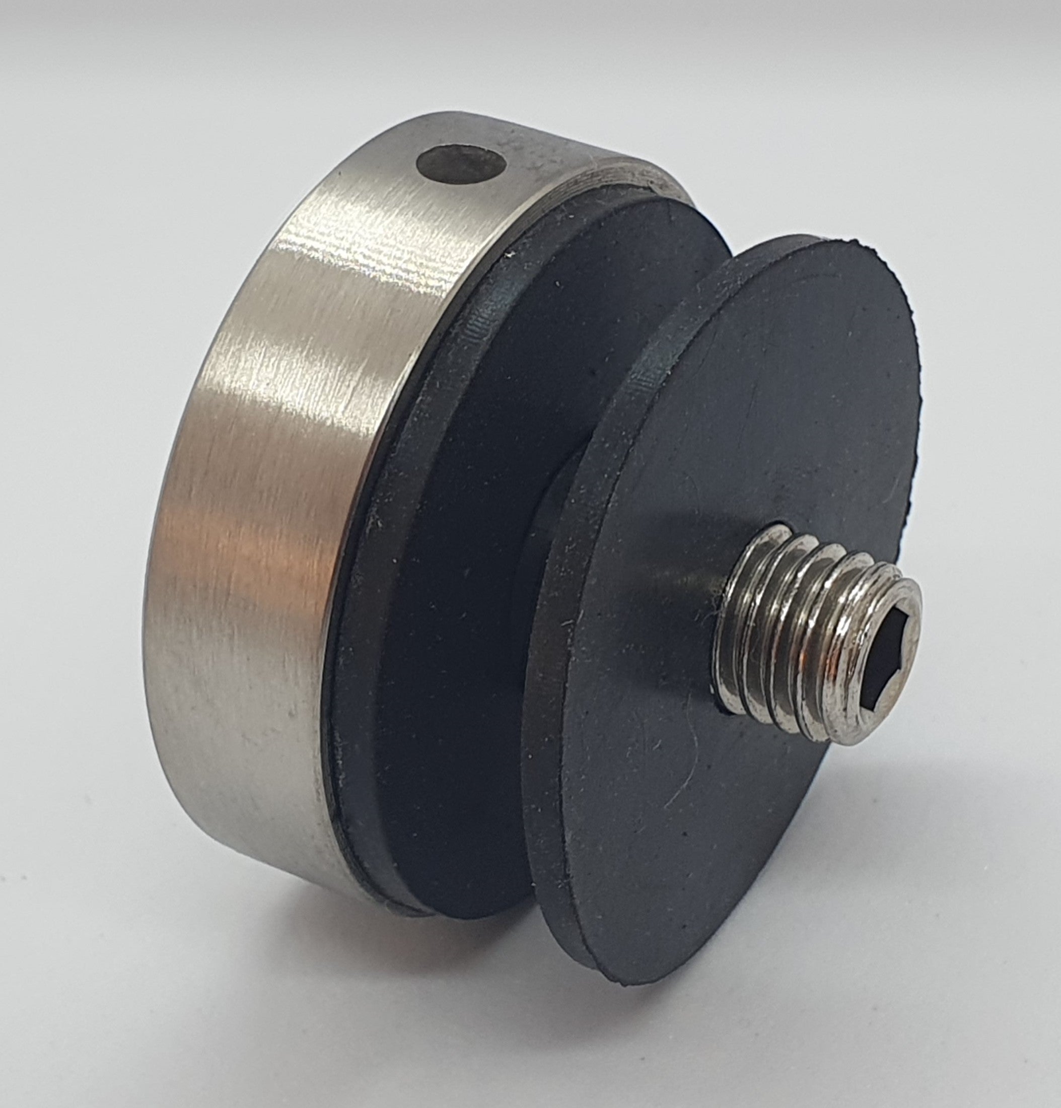 Metallic and black mechanical component on a white background